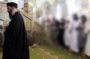 An image grab taken from a propaganda video released on July 5, 2014 by al-Furqan Media allegedly shows the leader of the Islamic State group, Abu Bakr al-Baghdadi, aka Caliph Ibrahim, leading prayers at a mosque in Mosul