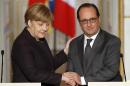 French president Francois Hollande, right, shakes hands with German Chancellor Angela Merkel at the end of a joint press conference at the Elysee Palace, in Paris, Wednesday, Nov. 25, 2015. Merkel's visit to Paris is part of president Hollande's diplomatic offensive to get the international community to bolster the campaign against the Islamic State militants. (AP Photo/Francois Mori)