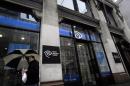 A man walks past the Time Warner Cable headquarters in New York