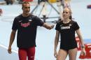 United States' Ashton Eaton, left, talks to his wife Canada's Brianne Theisen Eaton as they compete in the heptathlon and pentathlon during the Athletics Indoor World Championships in Sopot, Poland, Friday, March 7, 2014. (AP Photo/Alik Keplicz)