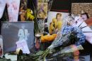 Memorabilia and bouquets of flowers are left in honor of David Bowie outside his New York apartment, Monday, Jan. 11, 2016. Bowie, the other-worldly musician who broke pop and rock boundaries with his creative musicianship, nonconformity, striking visuals and a genre-spanning persona he christened Ziggy Stardust, died of cancer Sunday. He was 69. (AP Photo/Mark Lennihan)