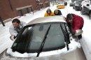 A group of men help push a sports car up a snow-covered street in the Old Port section of Portland, Maine, during a snow storm, Friday, Feb. 8, 2013. The storm is expected to dump up to two feet of snow on the region. (AP Photo/Robert F. Bukaty)