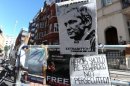 Signs from supporters of Julian Assange are left outside the Ecuadorian Embassy in London
