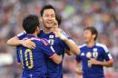 Maya Yoshida of Japan (C) celebrates scoring a goal against Palestine during their Group D football match of the AFC Asian Cup in Newcastle on January 12, 2015