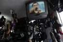 In this Aug. 25, 2012 photo, a TV set at a shoe shop shows President Rafael Correa talking on his weekly program 