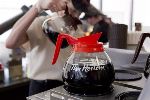 A server pours Tim Hortons' coffee in Toronto on May 10, 2012. THE CANADIAN PRESS/Chris Young
