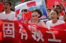 Chinese protesters shout slogans while holding anti-Japan banners during a protest in Luoyang