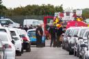 The emergency services attend the scene where a private jet crashed at a car auction lot next to Blackbushe Airport in Hampshire, southern England on August 1, 2015