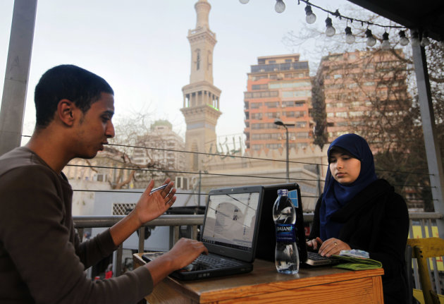 Egyptians log on to the Internet at a community center in front of a mosque in Cairo, Egypt, Saturday, Feb. 9, 2013. A Cairo court on Saturday ordered the government to block access to the video-sharing website YouTube for 30 days for carrying an anti-Islam film that caused deadly riots across the world. (AP Photo/Amr Nabil)