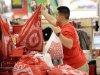 FILE - In this Nov. 23, 2012 file photo, a Target employee hands bags to a customer at the register at a Target store in Colma, Calif. Target's fiscal fourth-quarter net income dipped 2 percent as it dealt with intense competition during the crucial holiday season. But its adjusted results beat analysts' estimates and it forecast first-quarter earnings above Wall Street's view. (AP Photo/Jeff Chiu, File)