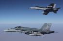 This photo taken on September 11, 2015 and released by the Royal Australian Air Force shows F/A-18A Hornets from Australia's Air Task Group flying in formation after refueling during the first mission of Operation OKRA to be flown over Syria