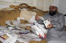 Egyptian cleric Hassan Mustafa Osama Nasr shows letters of well wishes from supporters during a Reuters interview in his house in Alexandria