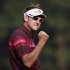 Poulter of England celebrates on the 18th green after winning the WGC-HSBC Champions Tournament at Mission Hills in Dongguan