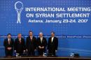 Russian, Turkish, Kazakh, Syrian, Iranian and UN counterparts pose after the announcement of a final statement following Syria peace talks in Astana on January 24, 2017