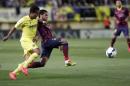 Barcelona's Alves and Villarreal's Dos Santos fight for the ball during their Spanish first division soccer match in Villarreal