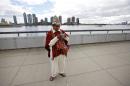 Tomas Mamani, of La Paz, Bolivia, looks at his camera after taking a photo outside United Nations headquarters, Monday, Sept. 22, 2014. The World Conference on Indigenous Peoples began Monday at the U.N. (AP Photo/Jason DeCrow)