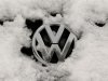 A snow-covered Volkswagen logo is pictured at a Volkswagen car dealer in the western city of Hamm