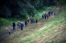 A group of migrants from Syria walk towards the border with Hungary, near the northern Serbian village of Martonos on June 25, 2015
