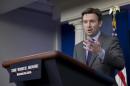 White House deputy press secretary Josh Earnest gestures as he speaks during the daily news briefing at the White House in Washington, Wednesday, Dec. 11, 2013. Earnest spoke about the Affordable Care Act, Syria and other topics. (AP Photo/Carolyn Kaster)
