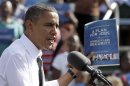President Barack Obama holds up a copy of his plan for jobs as he speaks to supporters during a campaign stop in Delray Beach, Fla., Tuesday, Oct. 23, 2012, a day after his last debate with Republican presidential candidate, former Massachusetts Gov. Mitt Romney. (AP Photo/Alan Diaz)