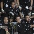 New Zealand All Blacks' team players pose with the trophy after beating Argentina Los Pumas to be crowned champions of Rugby Championship in La Plata