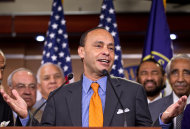 FILE - In this Aug. 2, 2012 file photo, Rep. Luis Gutierrez, D-Ill., center, accompanied by fellow House members, speaks during a news conference on Capitol Hill in Washington. House members writing a bipartisan immigration bill said Thursday they had patched over a dispute that threatened their efforts, even as they and the rest of Congress prepared to return home for a weeklong recess where many could confront voter questions on the issue. “I’m very pleased,” said Gutierrez. “We're going to get there. There's going to be justice done for our immigrant community.” (AP Photo/J. Scott Applewhite)