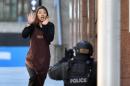 A hostage runs towards police in Sydney on December 15, 2014 from a cafe where a gunman had taken hostages and displayed an Islamic flag