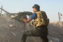 An Iraqi security forces personnel holds his weapon while taking position during clashes with Islamic State militants on the outskirts of Ramadi