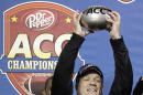 FILE - In this file photo from Dec. 7, 2013, Florida State head coach Jimbo Fisher, right, holds up a trophy as his son, Trey, left, looks on after the Atlantic Coast Conference Championship NCAA football game in Charlotte, N.C., Florida State defeated Duke 45-7. The No. 1-ranked Florida State held their final workout on campus Monday, Dec. 30 2013, before flying to California to face No. 2 Auburn in the BCS NCAA college football championship game. (AP Photo/Bob Leverone, file)