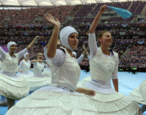 Dancers wave during opening ceremony of Euro 2012 soccer tournament in Warsaw