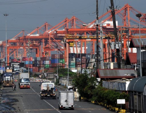 Cranes and container trucks are seen at the port of Manila on August 30. The Philippines said Thursday the economy grew a better-than-forecast 5.9 percent in the three months to June, largely due to a strong services sector