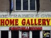 The façade of a furniture store is over the original sign for the gym where heavyweight champ Joe Frazier lived and trained, on Tuesday, April 30, 2013, in Philadelphia. The building has been named to the National Register of Historic Places.  (AP Photo/Matt Rourke)