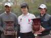 McIlroy of Northern Ireland holds winner's trophy as he poses with Woods of U.S. and Changge after matchplay exhibition event at Jinsha Lake Golf Club in Zhengzhou