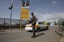 A policeman stands guard at the entrance of Sanaa International Airport, Yemen, Wednesday, Aug. 7, 2013. The State Department on Tuesday ordered non-essential personnel at the U.S. Embassy in Yemen to leave the country. The department said in a travel warning that it had ordered the departure of non-emergency U.S. government personnel from Yemen "due to the continued potential for terrorist attacks" and said U.S. citizens in Yemen should leave immediately because of an "extremely high" security threat level. (AP Photo/Hani Mohammed)