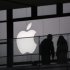 People walk past the Apple logo near an Apple Store at a shopping area in central Beijing