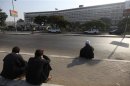 People sit in front of Maadi military hospital where Egypt's ousted president Hosni Mubarak was transferred from Tora prison, on the outskirts of Cairo