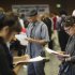 Job seekers fill out applications during 11th annual Skid Row Career Fair the Los Angeles Mission in Los Angeles