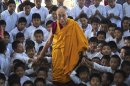 Exiled Tibetan spiritual leader the Dalai Lama poses for a picture with the students of a Tibetan school after inaugurating its auditorium at Gurupura in the southern Indian state of Karnataka July 14, 2013. REUTERS/Stringer