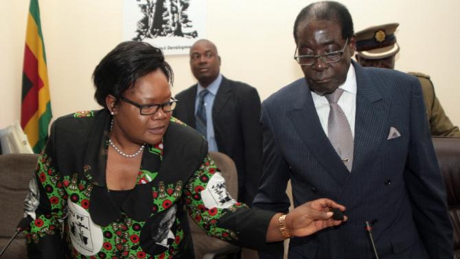 Zimbabwean President Robert Mugabe (R) and then Vice-President Joice Mujuru pictured at a meeting of the ruling ZANU-PF party headquarters in Harare in October 2014