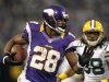 Minnesota Vikings running back Adrian Peterson, left, runs from Green Bay Packers cornerback Tramon Williams during the first half of an NFL football game Sunday, Dec. 30, 2012, in Minneapolis. (AP Photo/Genevieve Ross)