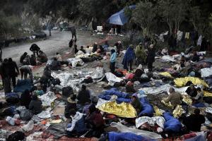 Migrants rest in a field on the Greek island of Lesbos&nbsp;&hellip;