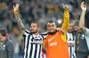 Juventus players Simone Pepe, left, and Arturo Vidal celebrate at the end of a Serie A soccer match againsts Atalanta, at the Juventus stadium, in Turin, Italy, Monday, May 6, 2014. Juventus clinched its third straight and 30th overall Serie A title. (AP Photo/Massimo Pinca)
