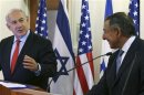 Israeli Prime Minister Netanyahu listens as U.S. Defense Secretary Panetta speaks to the media before a meeting at the Prime Minister's office in Jerusalem