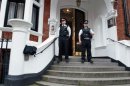 Metropolitan Police Officers wait outside the main door of the Ecuadorian embassy in London