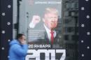 A pedestrian walks past the store "Army of Russia", with an image of U.S. President-elect Donald Trump seen on the advertising banner, in Moscow
