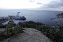 The Costa Concordia cruise ship leans on its side of the Tuscan Island Isola del Giglio, Italy, Saturday, Jan. 12, 2013. More time and money will be needed to remove the Costa Concordia cruise ship from the rocks off Tuscany where it capsized last year, in part to ensure the toxic materials still trapped inside don't leak into the marine sanctuary when it is righted, officials said Saturday. On the eve of the first anniversary of the grounding, environmental and salvage experts gave an update on the unprecedented removal project under way, stressing the massive size of the ship — 112,000 tons, its precarious perch on the rocks off the port of Giglio island and the environmental concerns at play. (AP Photo/Gregorio Borgia)