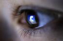 A picture illustration shows a Facebook logo reflected in a person's eye, in Zenica