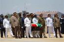The coffin of Mandela is escorted aboard a military cargo plane after a send-off ceremony at Waterkloof Air Force base in Pretoria