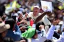 Pope Francis waves from the popemobile in San Cristobal de Las Casas on February 15, 2016