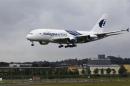 An Airbus A380, owned by Malaysia Airlines, lands ahead of the Farnborough Airshow 2012 in southern England